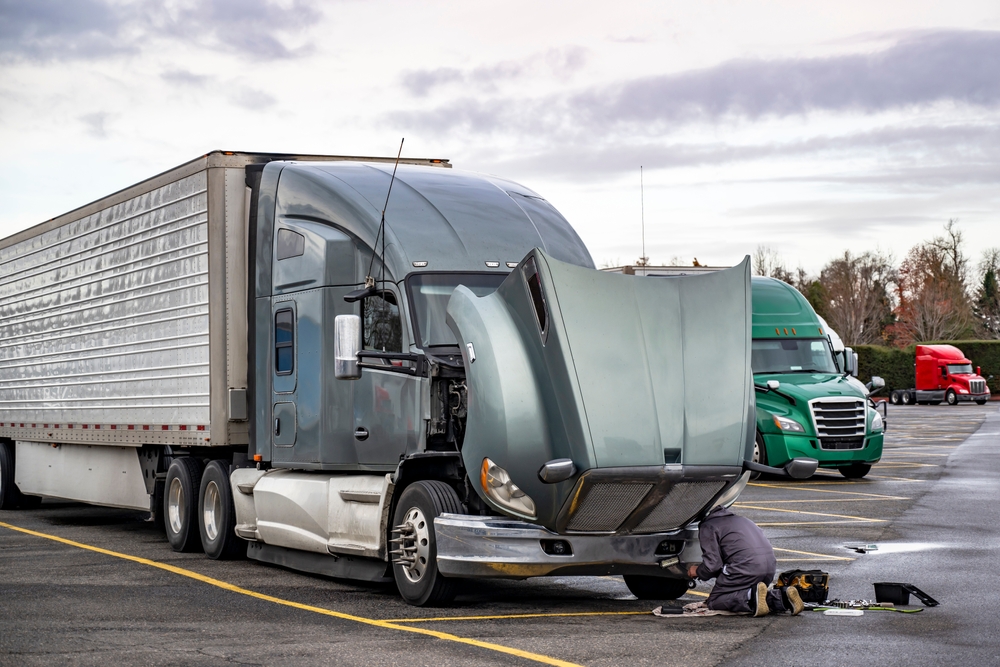 Truck,driver,repairing,broken,gray,big,rig,semi,truck,with