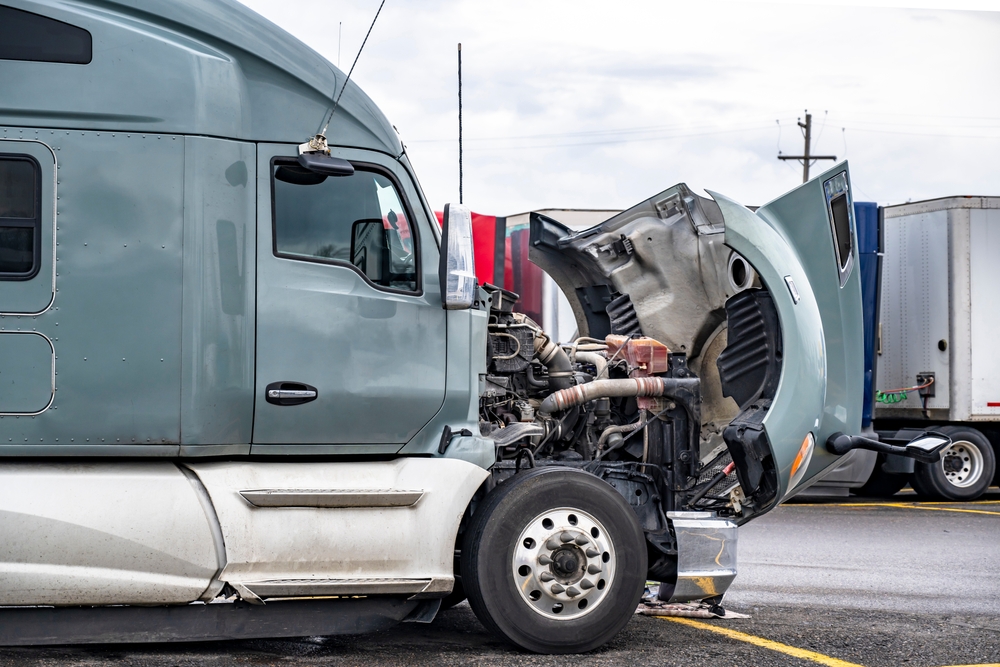 Broken,big,rig,gray,semi,truck,with,open,hood,standing